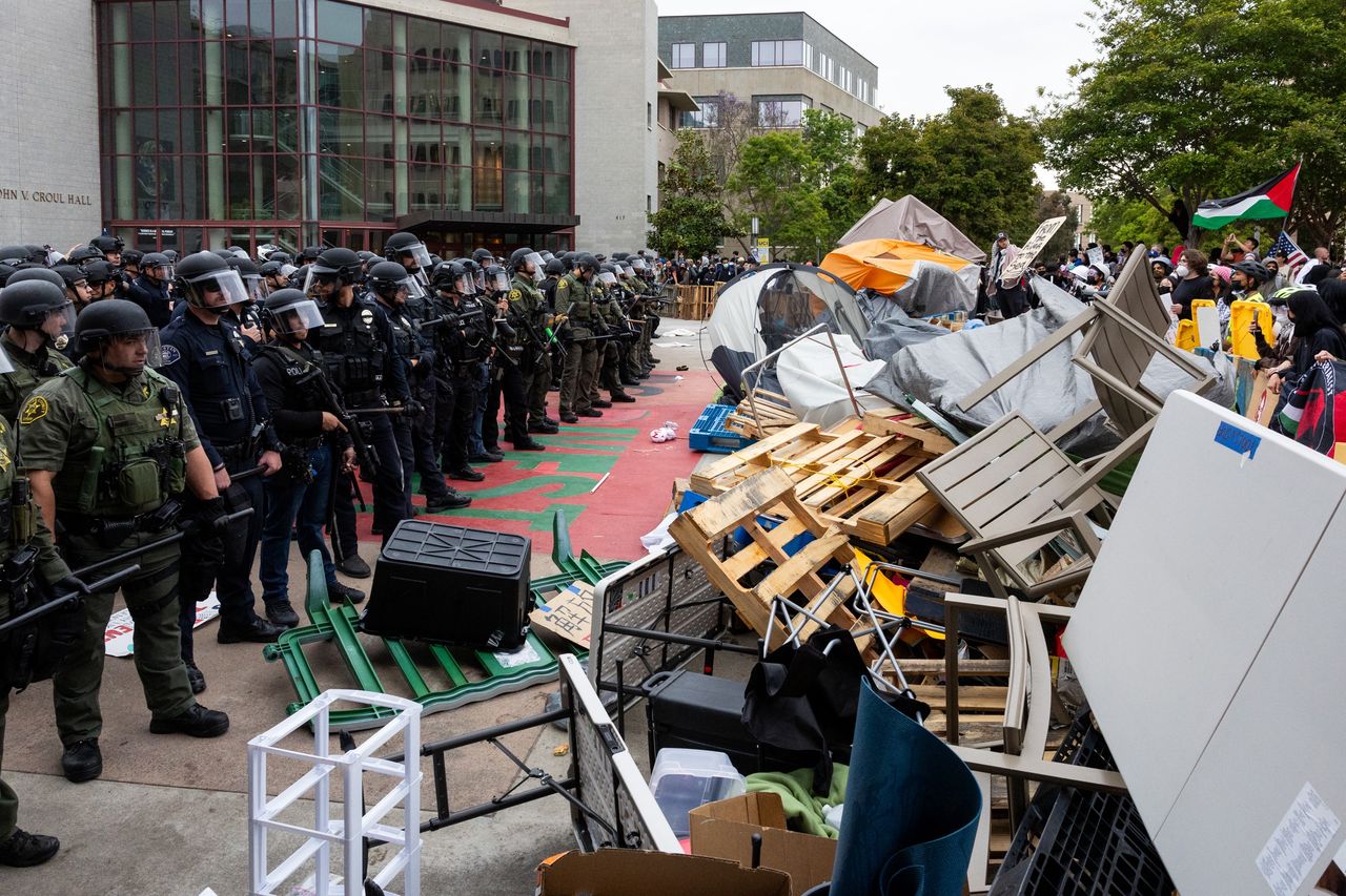 IRVINE, CA - MAY 15: Pro-Palestinian demonstrators block the road as police officers try to clear a pro-Palestinian protest encampment at the University of California at Irvine (UCI) on May 15, 2024 in Irvine, California. (Photo by Qian Weizhong/VCG via Getty Images)