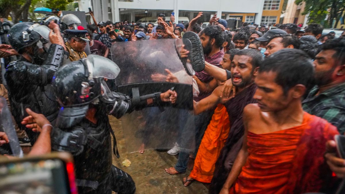 Protesters clash with an anti-riot police unit in Colombo, Sri Lanka, on January 16, 2023. The protest was held to demand the release of imprisoned Inter University Students' Federation convener Wasantha Mudalige and demand solutions to rising commodity prices. These protestors marched to many places in Colombo with placards, and the police anti-riot unit fired water and tear gas and dispersed the protest. (Photo by Thilina Kaluthotage/NurPhoto via Getty Images)