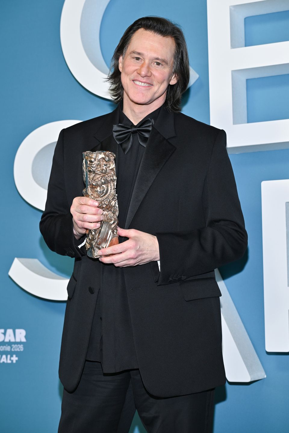 PARIS, FRANCE - FEBRUARY 26:  Jim Carrey poses in the winners room with the "Honorary" Award  during the 51st Cesar Film Awards at L'Olympia on February 26, 2026 in Paris, France. (Photo by Dominique Charriau/WireImage)