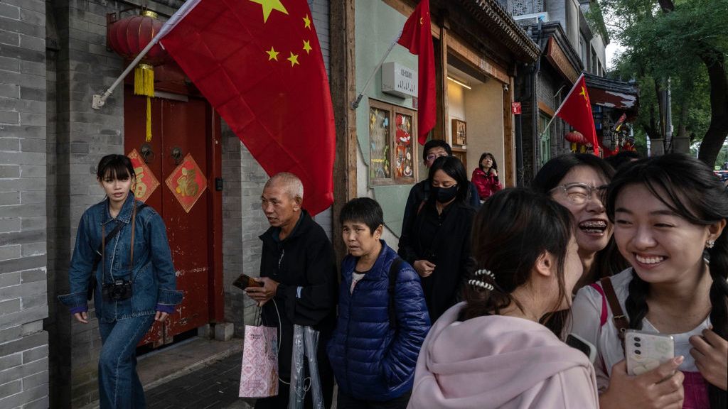 China Prepares to Celebrate the National Day and Golden Week Holidays
BEIJING, CHINA - SEPTEMBER 30: People walk by the national flag of China as they hang outside residences and shops in a historic neighbourhood for the upcoming National Day on September 30, 2024 in Beijing, China. China will celebrate the 75th anniversary of the founding of the Peoples Republic of China on October 1st. (Photo by Kevin Frayer/Getty Images)
Kevin Frayer