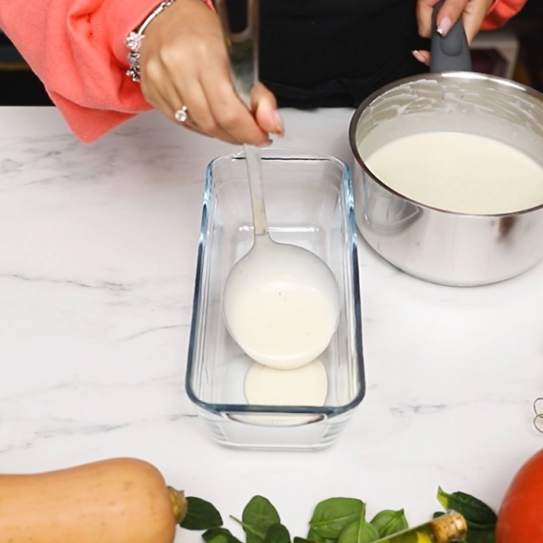 I spread the creamy sauce in the baking dish.