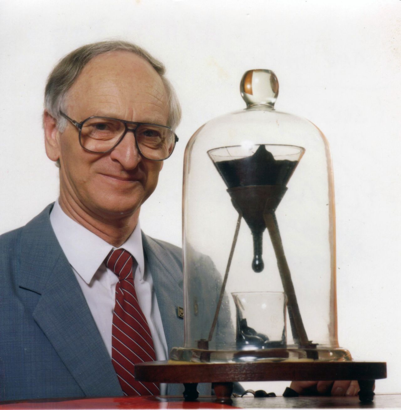 John Mainstone by the funnel with the pitch in 1990, two years after the seventh drop fell.