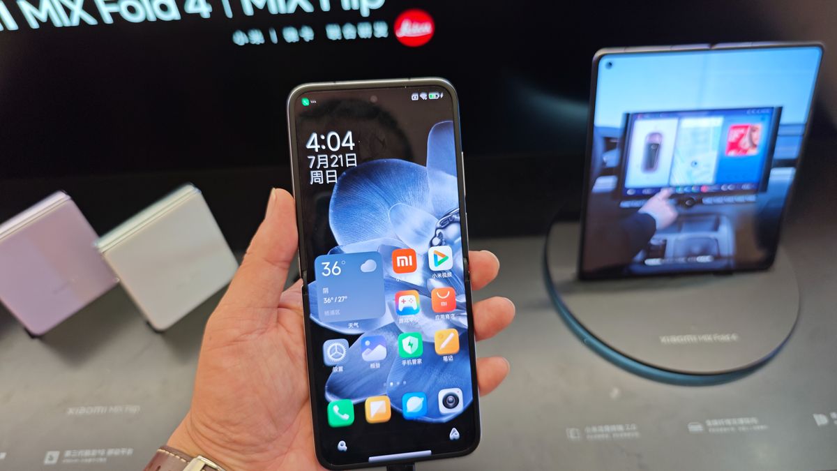 Customers are experiencing two fold-screen phones newly released by Xiaomi at a Xiaomi Home in Shanghai, China, on July 21, 2024. (Photo by Costfoto/NurPhoto via Getty Images)