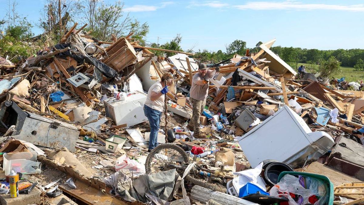 David and Edwina Wilson clean up and take items to be saved from their Sunshine Hills home, Sunday, May 18, 2025, in London, Kentucky. Their home was destroyed when a deadly tornado ripped through the neighborhood two days earlier. They stayed in the home during the storm. "The walls just fell down around them," Joe Wilson, their son, said. (Brian Simms/Lexington Herald-Leader/Tribune News Service via Getty Images)