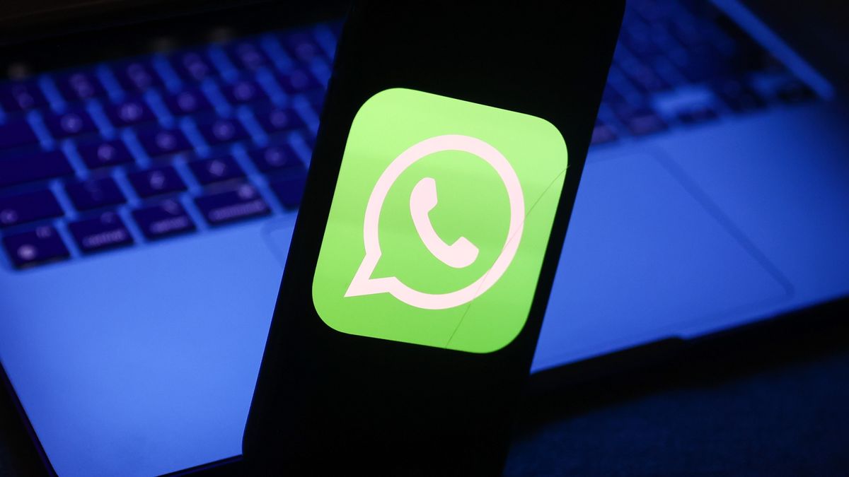 WhatsApp logo displayed on a phone screen and a laptop are seen in this illustration photo taken in Krakow, Poland on November 27, 2022. (Photo by Jakub Porzycki/NurPhoto via Getty Images)