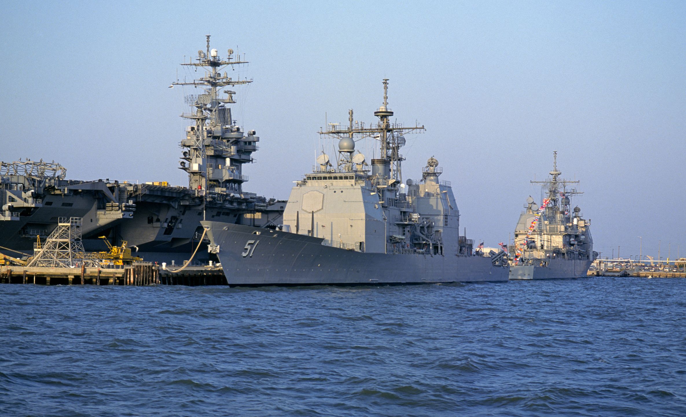 The United States Aircraft Carrier USS DWIGHT D. EISENHOWER (CVN 69) (left), and two ARLEIGH BURKE class guided missile AEGIS destroyers at the Norfolk Naval Base, Norfolk, Virginia, 2005. (Photo By Buddy Mays/Getty Images).