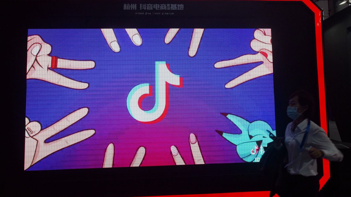 HANGZHOU, CHINA - OCTOBER 17 2021: A woman walks by an advert of TikTok at an e-commerce expo in Hangzhou in east China's Zhejiang province Sunday, Oct. 17, 2021. (Photo credit should read LONG WEI/ Feature China/Future Publishing via Getty Images)