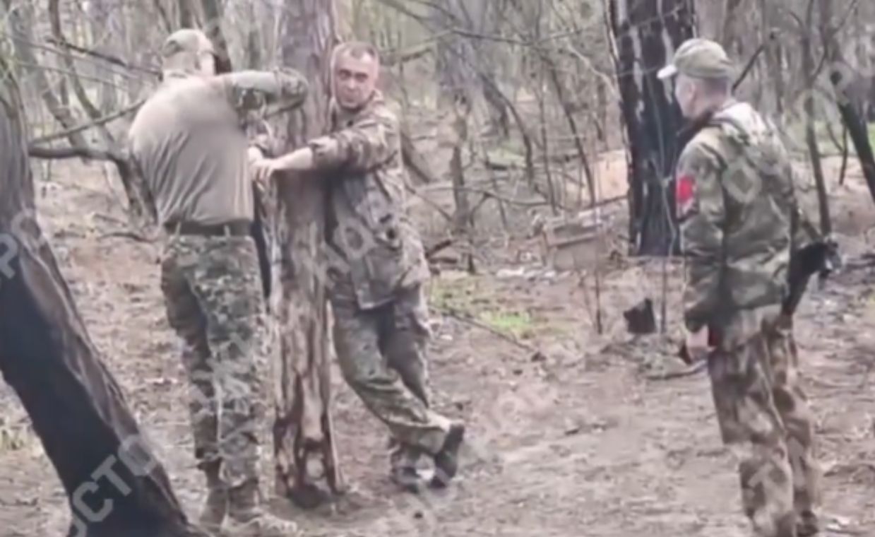 A Russian commander tied to a tree during shelling