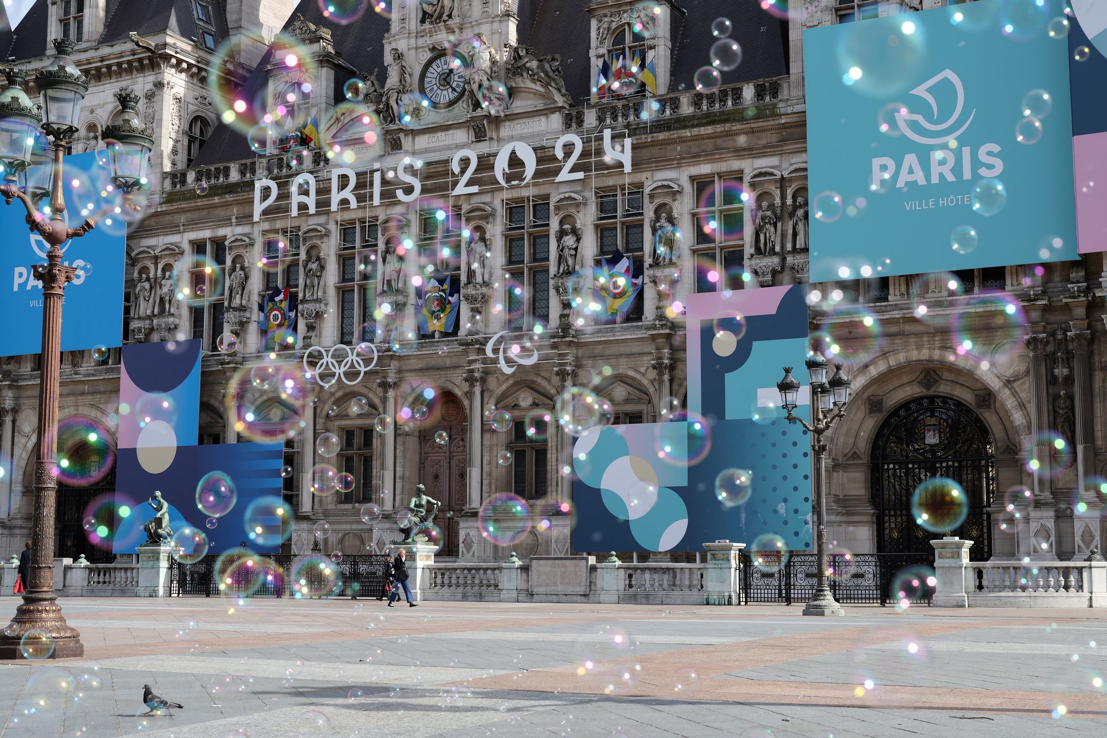 Landmarks Around Paris Ahead Of The Summer Olympics
PARIS, FRANCE - MARCH 14:  The Paris 2024 logo, representing the Olympic and Paralympic Games four months prior to the start of the Paris 2024 Olympic and Paralympic games is displayed on the facade of Paris town hall as soap bubbles float in the air on March 14, 2024 in Paris, France. The city is gearing up to host the XXXIII Olympic and Paralympic Summer Games, from 26 July to 11 August. (Photo by Pascal Le Segretain/Getty Images)
Pascal Le Segretain