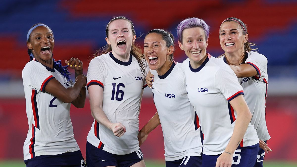 YOKOHAMA, JAPAN - JULY 30: Crystal Dunn #2, Rose Lavelle #16, Christen Press #11, Megan Rapinoe #15 and Alex Morgan #13 of Team United States celebrate following their team's victory in the penalty shoot out after the Women's Quarter Final match between Netherlands and United States on day seven of the Tokyo 2020 Olympic Games at International Stadium Yokohama on July 30, 2021 in Yokohama, Kanagawa, Japan. (Photo by Laurence Griffiths/Getty Images)