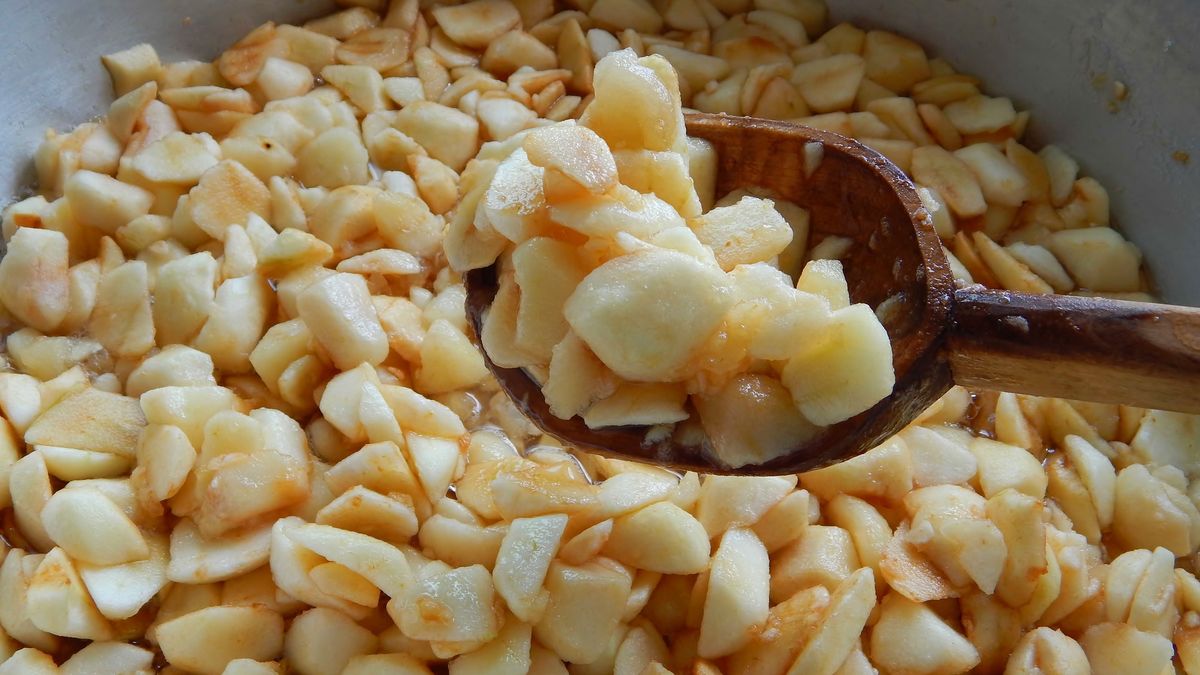 apples sliced in slices with squares in a wooden spoon, apple jam is brewed
apples sliced in slices with squares in a wooden spoon, apple jam is brewed.