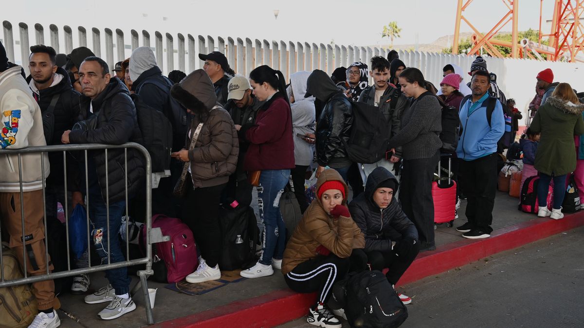 Asylum seekers wait for their CBP One appointments before crossing through El Chaparral border port in Tijuana, Mexico, on January 20, 2025. The Trump administration shuts down the CBP One app for migrants. The Biden-era process allows nearly 1 million migrants to enter the US at legal border crossings since the app initiates. It is estimated that 270,000 migrants wait in Mexico, hoping to use the app to enter the US. (Photo by Carlos Moreno/NurPhoto via Getty Images)