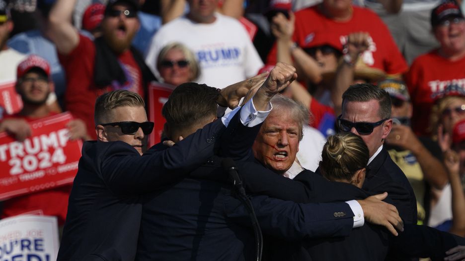 BUTLER, PENNSYLVANIA - JULY 13:  Republican presidential candidate, former U.S. President Donald Trump is whisked away by Secret Service after shots rang out at a campaign rally at Butler Farm Show Inc. on July 13, 2024 in Butler, Pennsylvania. Trump slumped and injuries were visible to the side of his head. Butler County district attorney Richard Goldinger said the shooter and one audience member are dead and another was injured.  (Photo by Jeff Swensen/Getty Images)
