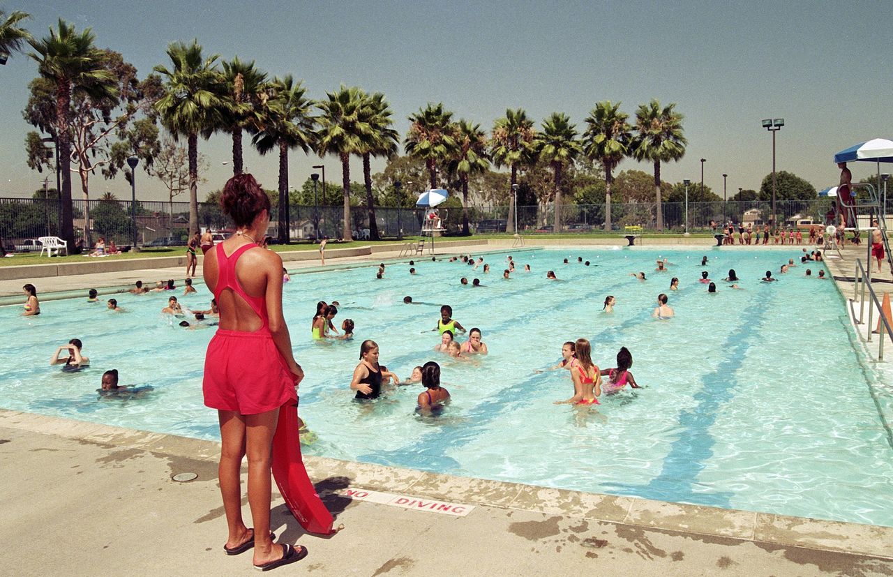 Lifeguards keep a watchful eye on children and adults while they enjoy the cool water at Mayfair Community swimming pool on a summer day, July 1, 1997 in Lakewood, California. (Photo by Bob Riha, Jr./Getty Images)