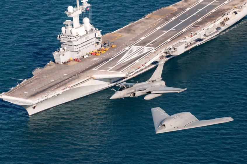 Dassault Rafale accompanied by the nEUROn drone against the backdrop of the aircraft carrier Charles de Gaulle