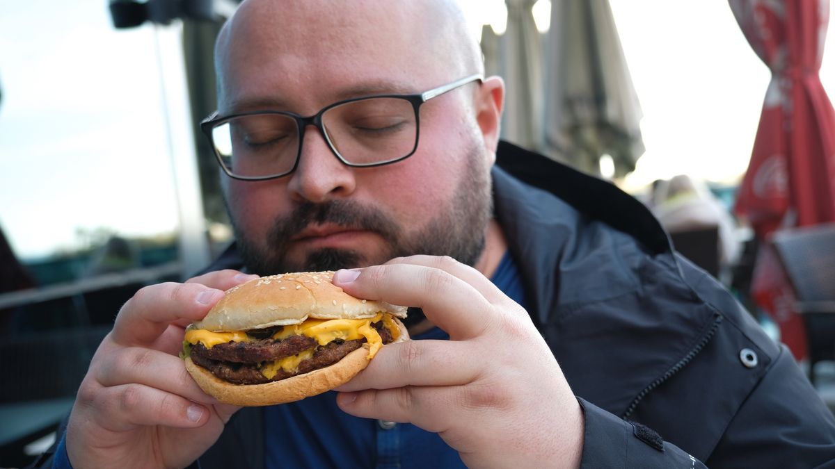 A young man is holding a piece of hamburger in his hands. A bearded guy or man eats fast food. A hungry fat guy is eating an appetizing burger. The concept of junk food, diet, overeating, gluttony, dependence on food. Fast food restaurant, snack.
A young man is holding a piece of hamburger in his hands. A bearded guy or man eats fast food. A hungry fat guy is eating an appetizing burger. The concept of junk food, diet, overeating, gluttony, dependence on food. Fast food restaurant, snack.
Aleksandr Zubkov