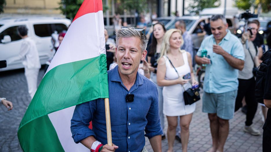Peter Magyar, leader of the Tisza Party, holding a Hungarian flag during a campaign event in Debrecen, Hungary, on Tuesday, July 22, 2025. Magyar is currently on an 80-day tour of the nation sounding out locals about their problems ahead of next year's elections. Photographer: Akos Stiller/Bloomberg via Getty Images