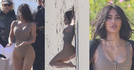 Smagana wiatrem Kim Kardashian eksponuje podrasowane kształty na plaży, reklamując swoje kostiumy (ZDJĘCIA)
