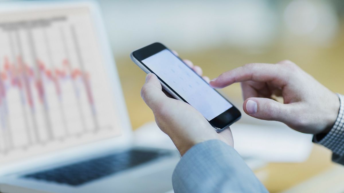 Caia Singles May 2016Close up of businessman dialing cell phone at laptopRobert Daly
