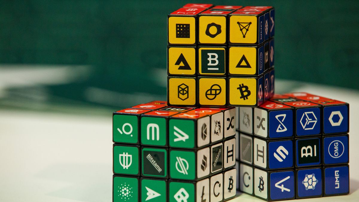 Puzzle cubes displaying logos of different cryptocurrencies and exchanges at the CryptoCompare Digital Asset Summit at Old Billingsgate in London, U.K., on Wednesday, March 30, 2022. Bitcoin and other cryptocurrencies had been, up until the last few weeks, mired in a similar downtrend as other riskier assets, like U.S. stocks. Photographer: Luke MacGregor/Bloomberg via Getty Images