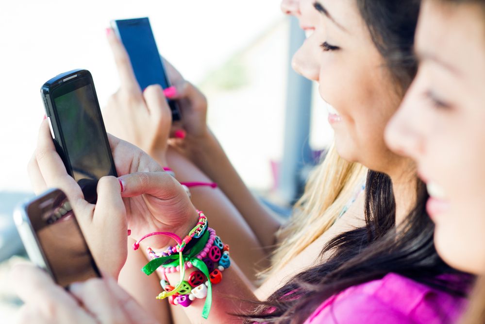 Zdjęcie dziewczyn ze smartfonami pochodzi z serwisu Shutterstock