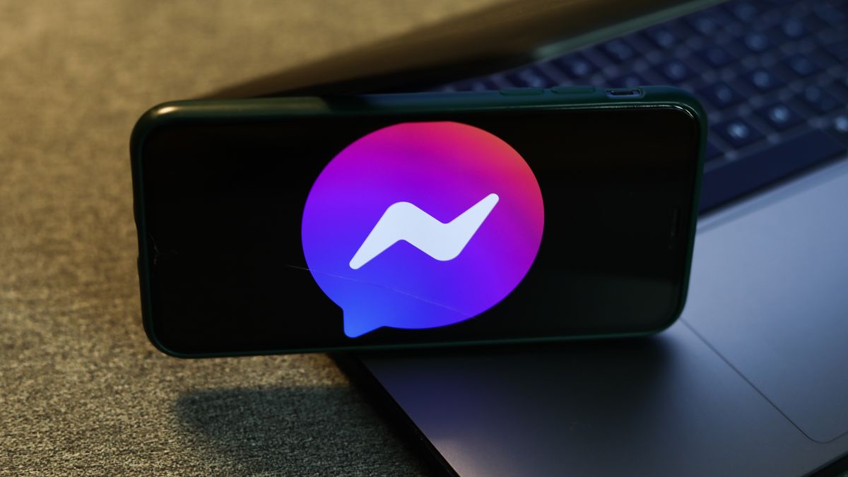 Messenger logo displayed on a phone screen and a laptop keyboard are seen in this illustration photo taken in Krakow, Poland on August 10, 2022. (Photo by Jakub Porzycki/NurPhoto via Getty Images)