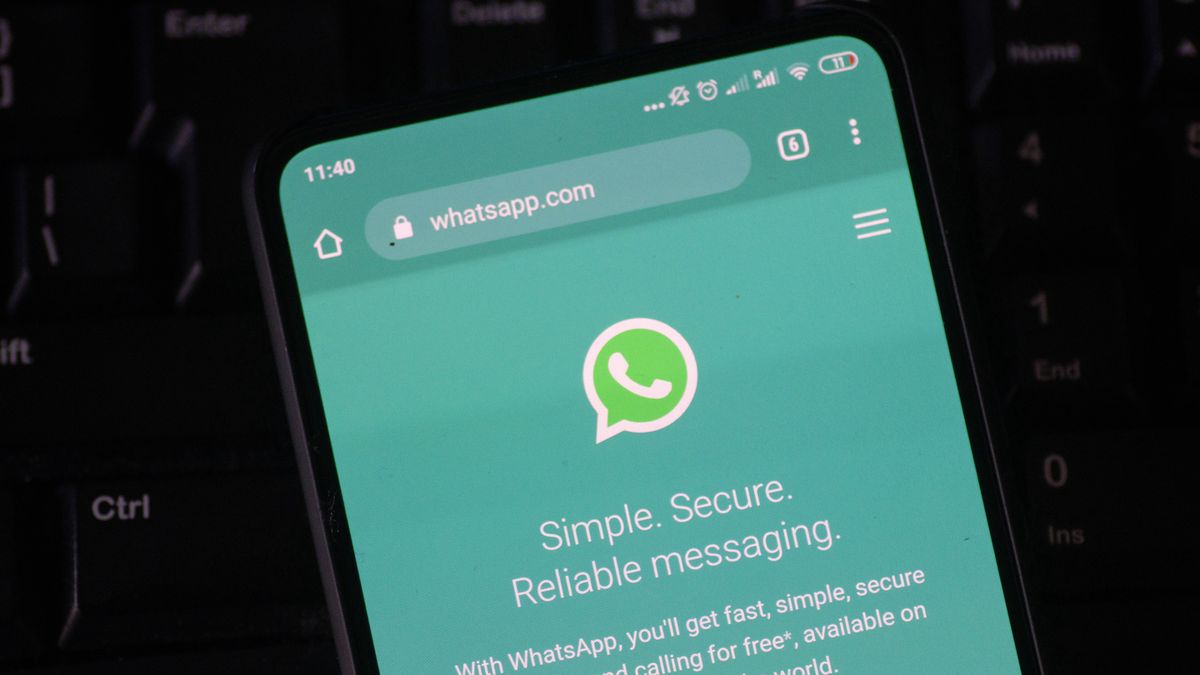 WhatsApp logo displayed on a phone screen, smartphone and keyboard are seen in this multiple exposure illustration. WhatsApp Messenger is a multiplatform mobile application that provides an encrypted instant messaging system belonging to Facebook, photo taken in Amsterdam, Netherlands on January 28, 2020 (Photo illustration by Nicolas Economou/NurPhoto via Getty Images)