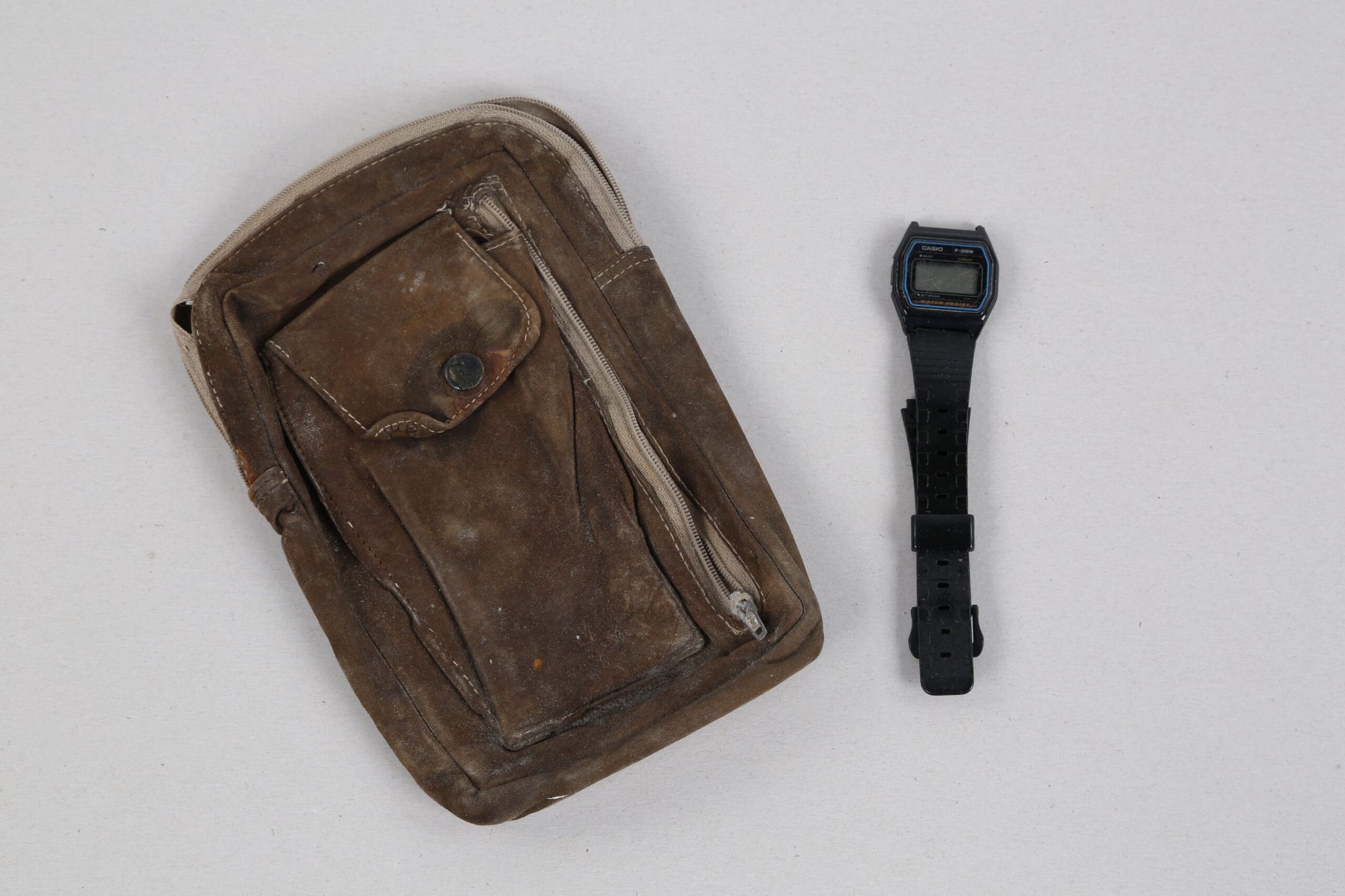 Saszetka i zegarek ocalonego z katastrofy Grzegorza Sudwoja