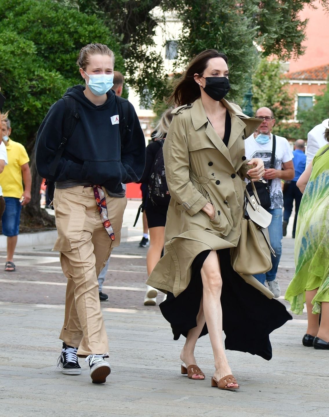 The American Hollywood Actress Angelina Jolie looked chic and stylish as she arrived on holiday out in Venice.
VENICE, ITALY  - The American Actress Angelina Jolie looked stylish and chic as she wore her brown mac coat and matching handbag as she arrived in Venice.

The Hollywood Actress wore also wore her face mask to avoid the threat of the ongoing COVID-19 pandemic as she was accompanied by her children and a mystery gentleman.

BACKGRID UK 30 JULY 2021,Image: 624421266, License: Rights-managed, Restrictions: RIGHTS: WORLDWIDE EXCEPT IN ITALY, Model Release: no, Credit line: Cobra Team / BACKGRID / Backgrid UK / Forum
Cobra Team / BACKGRID / Backgrid UK / Forum
American Actress, Angelina Jolie, stylish, chic, brown mac coat, matching handbag, Venice, Hollywood Actress, face mask, COVID-19, pandemic.