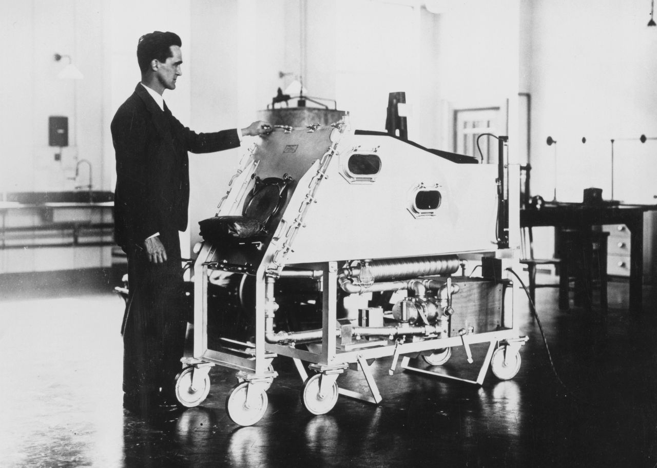 'Professor Philip Drinker with the 'life machine' he has invented which forces a patient's lungs to open and close'. Philip Drinker invented the iron lung - used to maintain artificial respiration - in 1928. (Photo by Daily Herald Archive/National Science & Media Museum/SSPL via Getty Images)