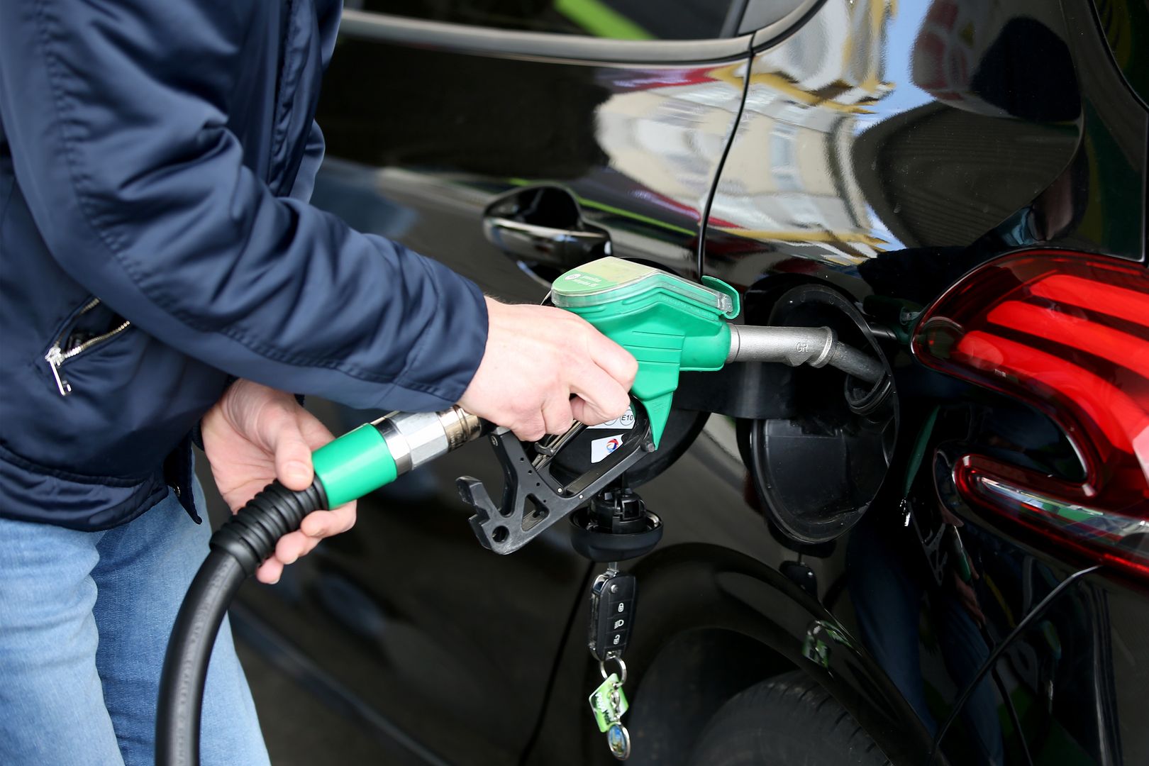 A driver fills up the tank of his car at a Gas station with the new price of fuel exceeding 2 euro per litre due to increases caused by the ongoing Russian invasion of Ukraine, in Lisbon, Portugal, on March 14, 2022. (Photo by Pedro Fiúza/NurPhoto via Getty Images)