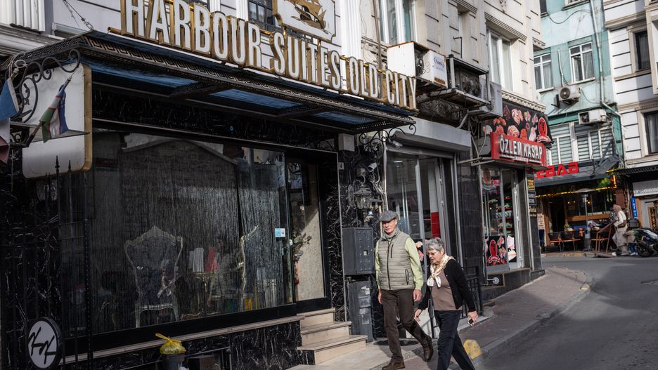 ISTANBUL, TURKEY - NOVEMBER 18: People walk past the Harbour Suites Old City Hotel on November 18, 2025 in Istanbul, Turkey. The hotel is at the center of a major investigation after a German-Turkish, father, mother and their two young children died while staying at the hotel. The family reportedly fell ill after eating street food, however as investigations continued attention turned to possible pesticide exposure after information emerged that a ground floor room had recently been treated with chemicals. A further two tourists staying at the hotel were also hospitalised after displaying symptoms of nausea and vomiting. Authorities have detained eleven people including, hotel staff, street food vendors and pest control workers as the investigation continues.  (Photo by Chris McGrath/Getty Images)