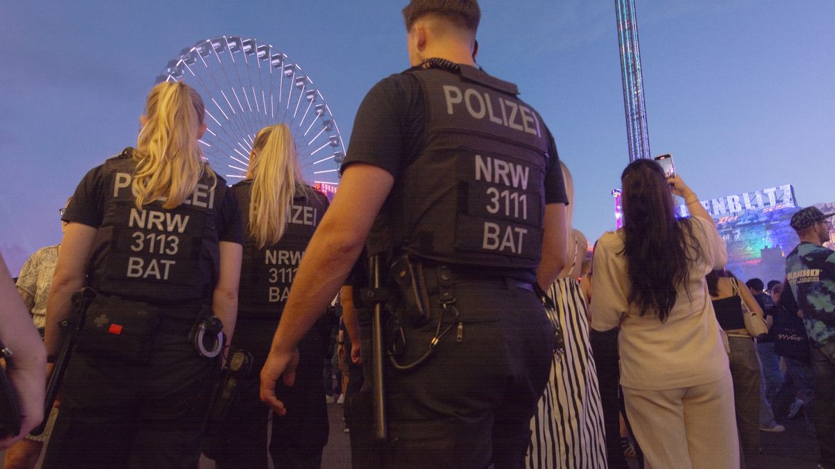 Police observe the crowd as people attend the traditional Puetzchen fun fair in Bonn, Germany, on September 7, 2024, after the Solingen stabbing attack during the festival. (Photo by Ying Tang/NurPhoto via Getty Images)