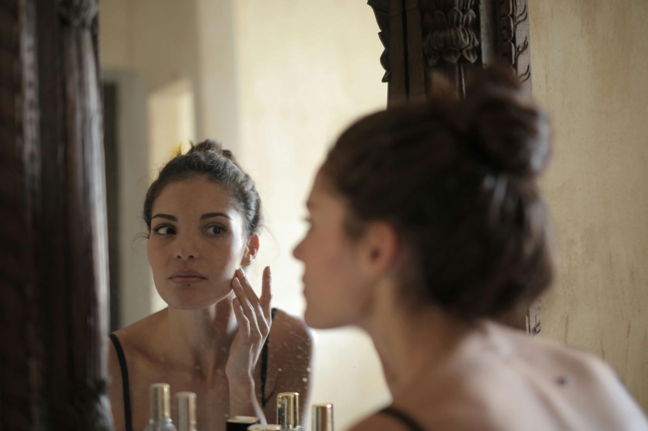 A woman examining her complexion.