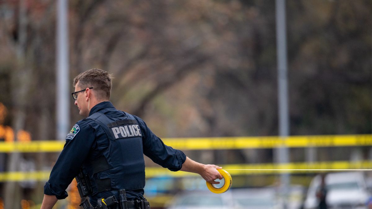 AUSTIN, TEXAS - MARCH 01: An Austin police officer blocks off an intersection with caution tape near Buford's bar in downtown on March 01, 2026 in Austin, Texas. Three people are dead and 14 others hospitalized following a mass shooting early Sunday morning.  (Photo by Brandon Bell/Getty Images)