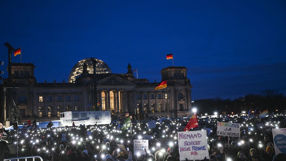 BERLIN, GERMANY - JANUARY 21: People protest against the far-right Alternative for Germany (AfD) political party and racism as they carry banners and hold flashlights near the Bundestag in Berlin, Germany on January 21, 2024. (Photo by Halil Sagirkaya/Anadolu via Getty Images)