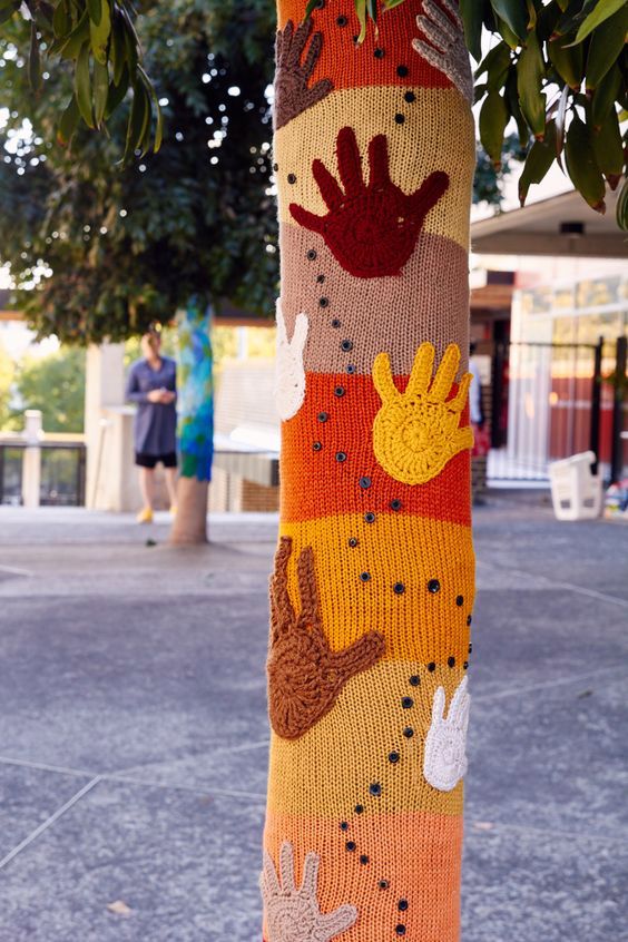 Installation of two of the new NCIE tree yarnbombs, the Hands of Harmony tree and Leaf tree. The third Meeting Place mandala tree yarnbomb didn't fit due to the trees having grown so much in the last year, despite Jane having included room for overlap, and will have to be fixed up and put up another time.