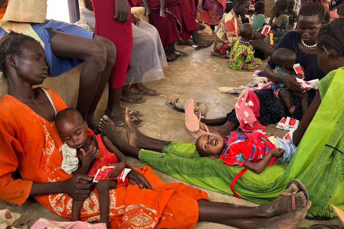 Akoot with her mother and other women with children at the Nutrition Center run by PCPM in Gordhim