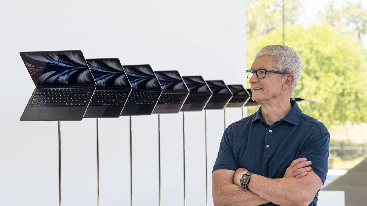 Tim Cook, chief executive officer of Apple Inc., next to a display of the new MacBook Air during the Apple Worldwide Developers Conference in Cupertino, California, US, on Monday, June 6, 2022. Apple unveiled the most significant overhaul to its popular MacBook Air laptop in more than a decade, bringing a fresh design, new colors and a speedier M2 processor from its homegrown chip line. Photographer: David Paul Morris/Bloomberg via Getty Images