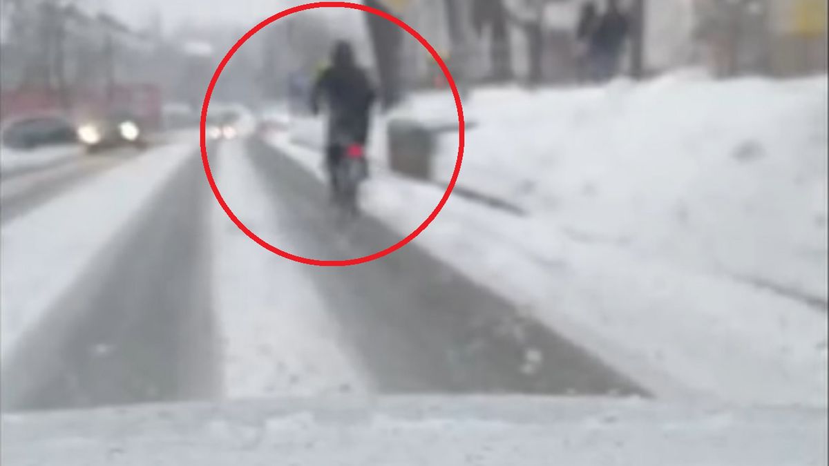 Rowerzysta jadący po oblodzonej drodze.