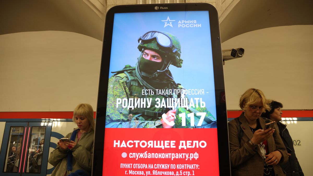 MOSCOW, RUSSIA - MAY 12: (RUSSIA OUT) Passengers walk past a billboard, advertising contract service in the army, at the subway station, on May 12, 2023 in Moscow, Russia.The Russian Ministry of Defense plans to recruit 400,000 contract soldiers this spring for the war in Ukraine. (Photo by Contributor/Getty Images)