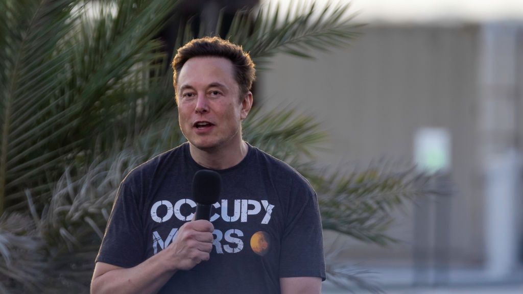 Na zdjęciu Elon Musk z mikrofonem i w koszulce "occupy Mars"