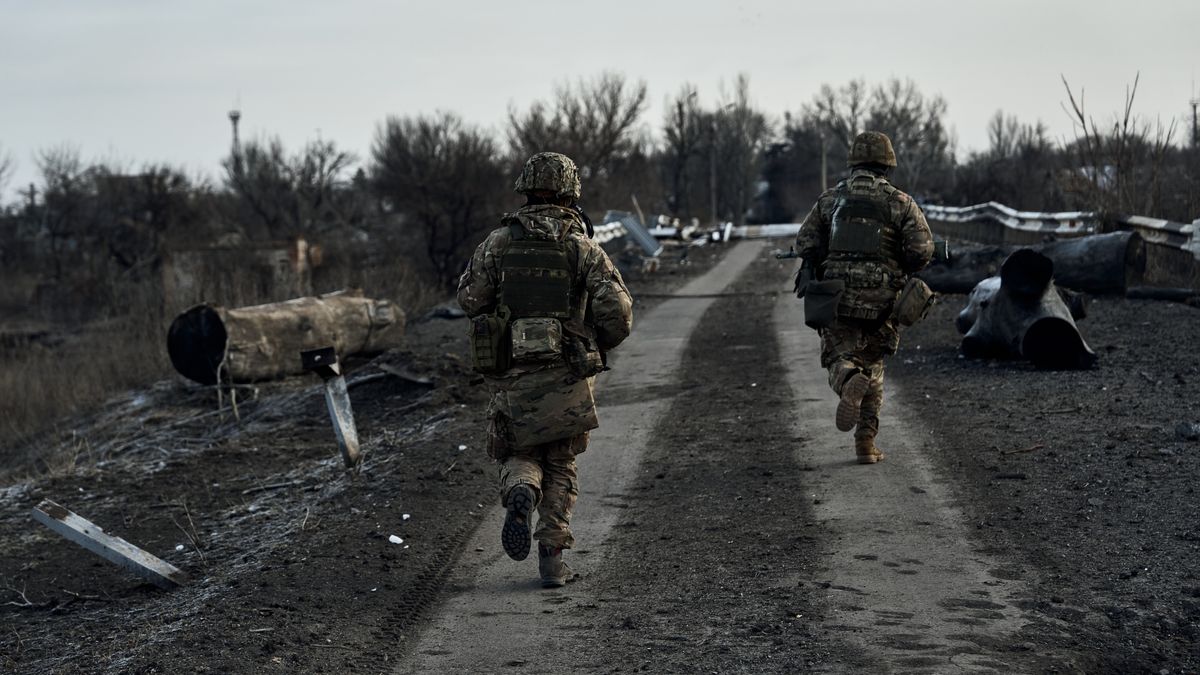 DONETSK REGION, FEBRUARY 24: Two Ukrainian soldiers run under missile fire on a bridge on February 24, 2023 in Donetsk region, Ukraine. In the village of Novosilka, located in the Donetsk region near the border with the Zaporizhzhia region, lies the Zaporozhia Frontline of the Russian-Ukrainian War. (Photo by Libkos/Getty Images)