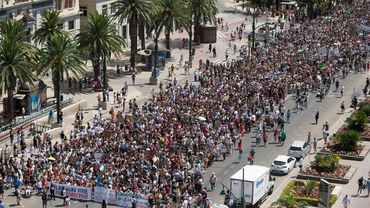 MALAGA, SPAIN - 2024/06/29: A general view shows protesters taking part in a demonstration against mass tourism in the city, following recent protests in the Canary and Balearic islands or Majorca. Thousands of people took to the streets in the centre of Malaga to protest against rising rental prices. Over the past few years, the city has experienced a significant housing crisis, largely due to rent speculation and a process of gentrification, which has made it difficult for many to access a decent rental housing system. Local neighbourhood associations and organisations are calling for measures to be introduced to limit rental prices and the impact of mass tourism. (Photo by Jesus Merida/SOPA Images/LightRocket via Getty Images)