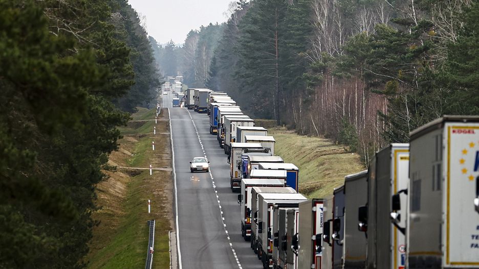 BOBROWNIKI, POLAND - NOVEMBER 15: Trucks wait in a queue of about 30 kilometers due to increase in controls and the transactions at the Bobrowniki border crossing while Polish police direct trucks to the Bobrowniki border gate after Poland's Kuznica border gate was closed for security reasons in Bobrowniki, Poland on November 15, 2021. (Photo by Abdulhamid Hosbas/Anadolu Agency via Getty Images)