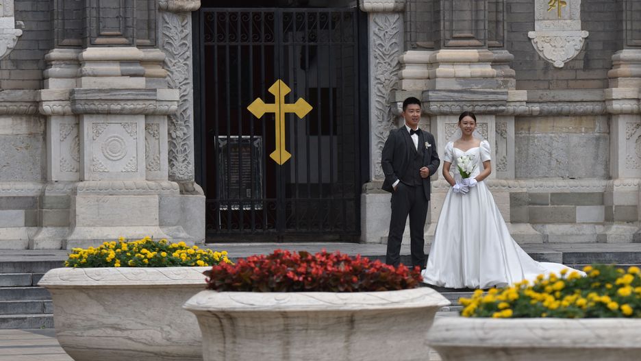 BEIJING, CHINA - 2021/09/15: A newly married couple takes wedding photos in front of the Catholic Church in Wangfujing Street, Beijing.
Wangfujing Catholic Church is one of the four major Catholic churches in Beijing. The existing church building of Wangfujing Catholic Church is a three story Romanesque building. (Photo by Sheldon Cooper/SOPA Images/LightRocket via Getty Images)