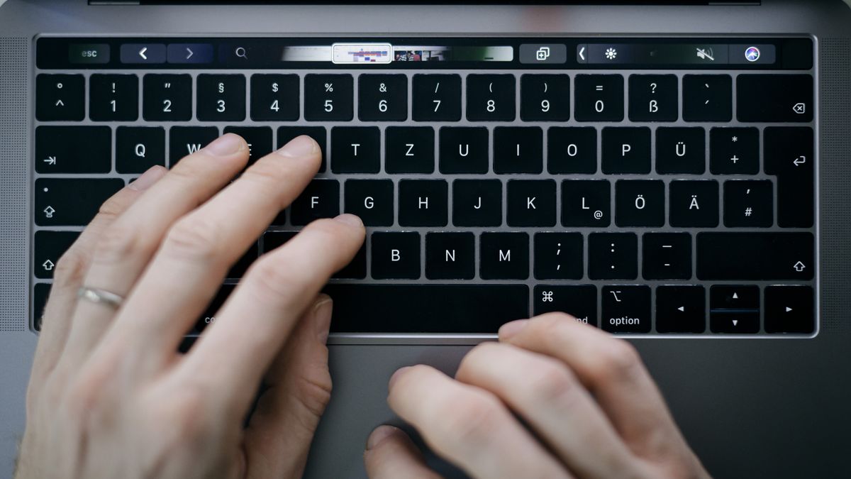 Hands typing on a computer keyboard