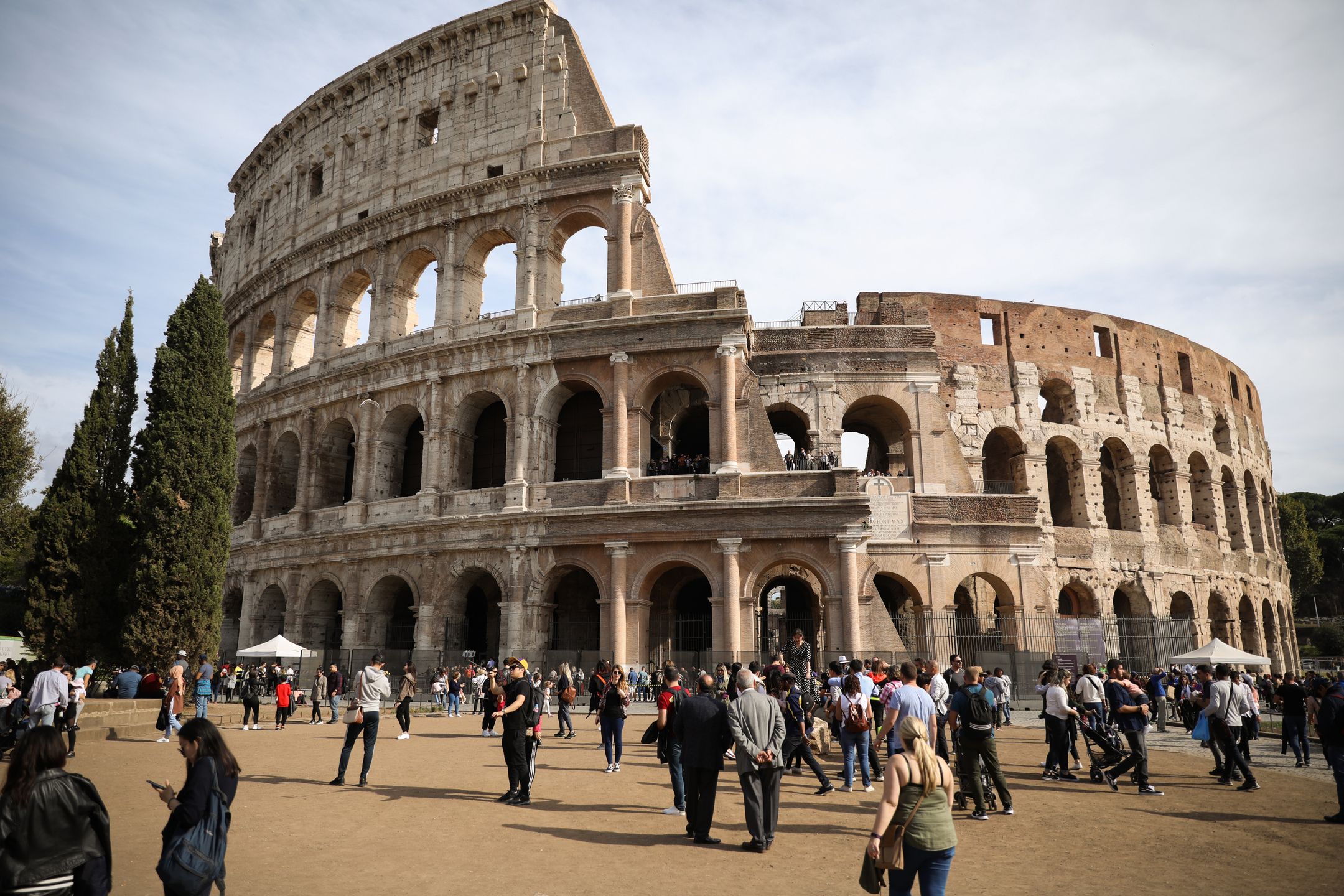 Tourists walking ahead of Coloseum in Rome, Italy (Photo by AB/NurPhoto via Getty Images)