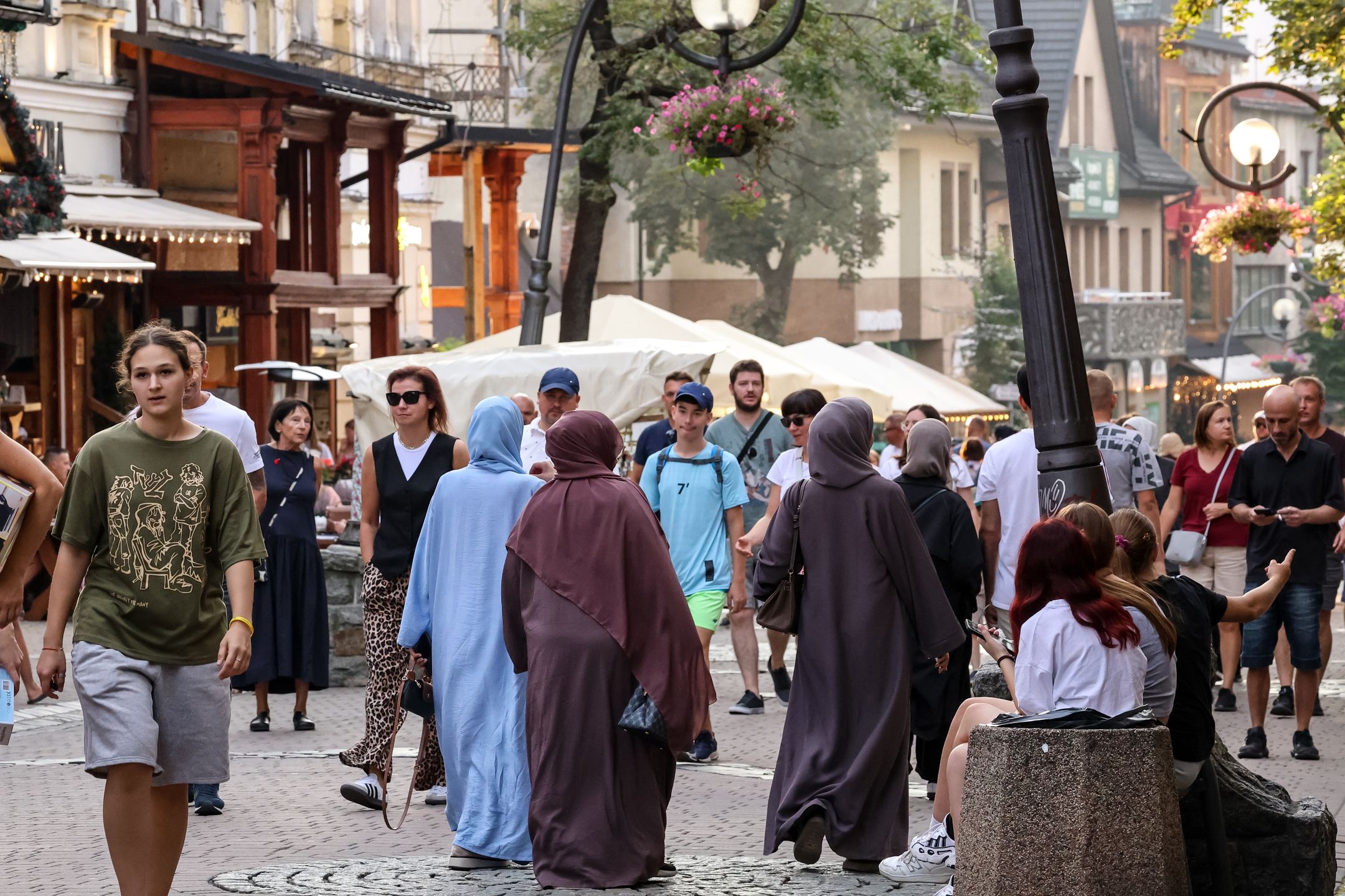 Families walk on a landmark Krupowki Street in the center of Zakopane, a popular Tatra mountain holiday resort on the last weekend of school holiday in Southern Poland on August 30, 2024. (Photo by Dominika Zarzycka/NurPhoto via Getty Images)