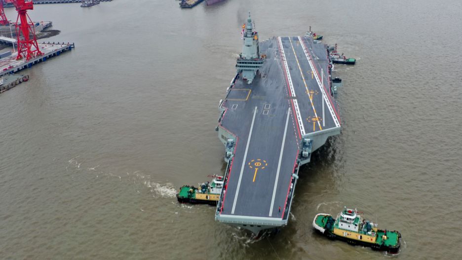 SHANGHAI, CHINA - MAY 01: The CNS Fujian, China's third aircraft carrier, begins its maiden sea trial on May 1, 2024 in Shanghai, China. The CNS Fujian, one of the most important pieces of military hardware China is working on, was officially unveiled in June 2022 in Shanghai as it was towed out of its dry dock at the China State Shipbuilding Corp's Jiangnan Shipyard. (Photo by Pu Haiyang/VCG via Getty Images)